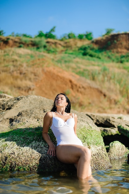 Beautiful sexy girl sunbathing on the sea.