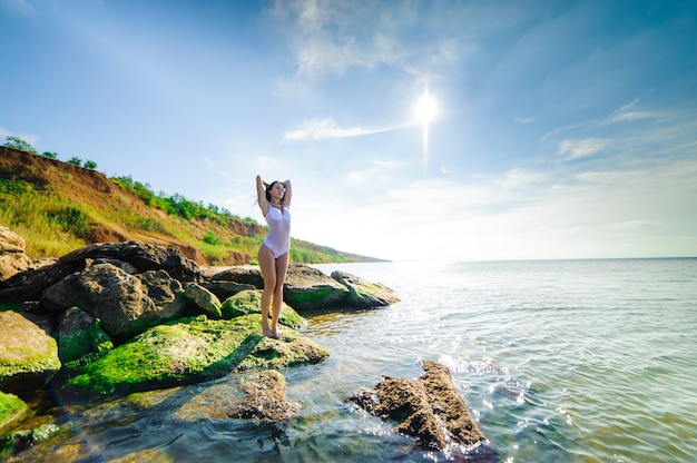 Beautiful sexy woman bathes in the sea.