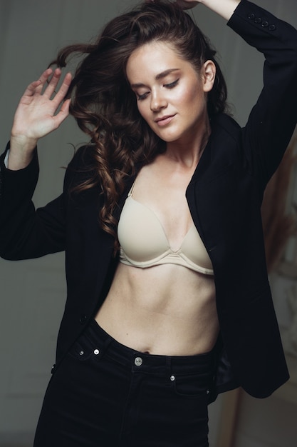 Beautiful sexy woman studio portrait black formal clothing