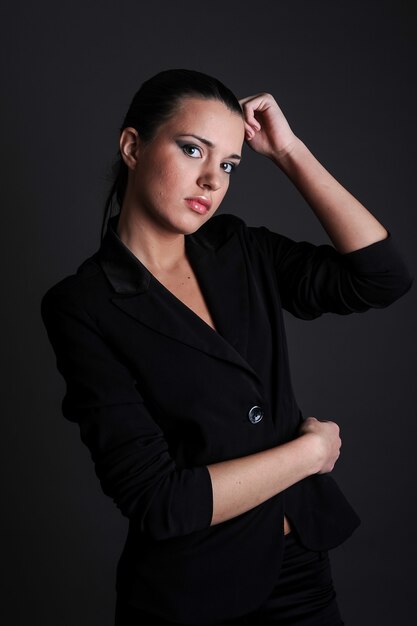 Beautiful sexy woman studio portrait black formal clothing