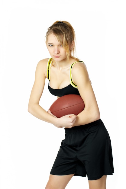 美しいセクシーな若い女性のアメリカンフットボール選手