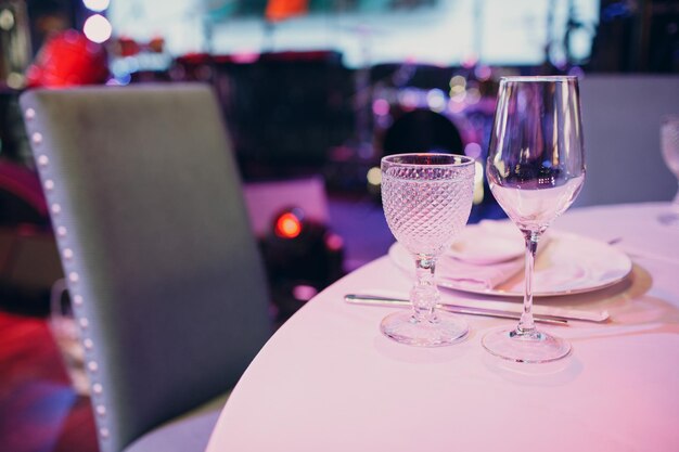 Beautiful shape empty wine glass on table in restaurant decor.