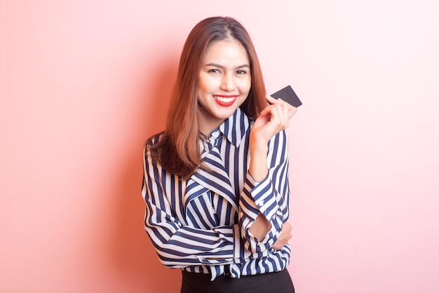 Beautiful shopping woman is smiling on pink  