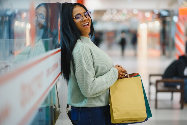 Beautiful shopping woman smiling and holding bags