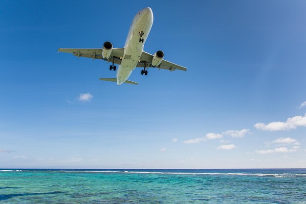 Beautiful shot of an airplane flying over the beach