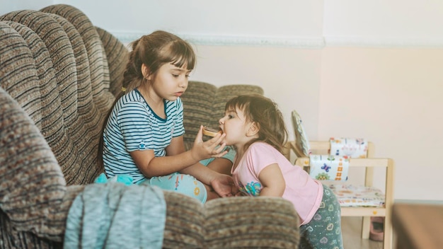 Beautiful shot of little sisters watching TV together