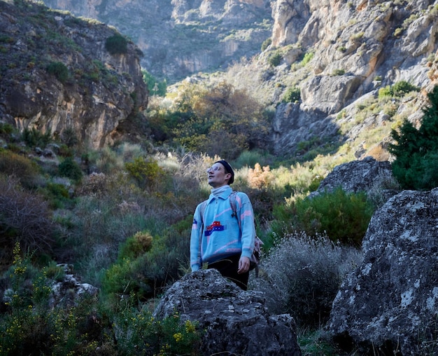 A beautiful shot of a person hiking in a forest during the day