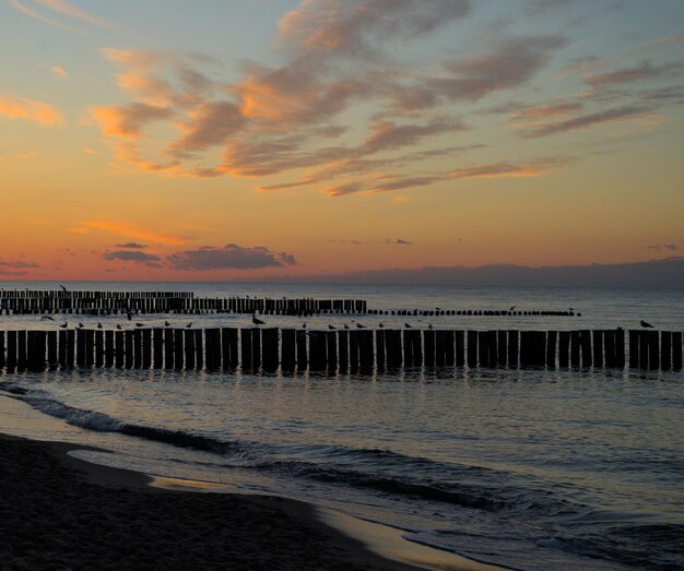 Beautiful shot of a seascape under the colorful clouds at sunset