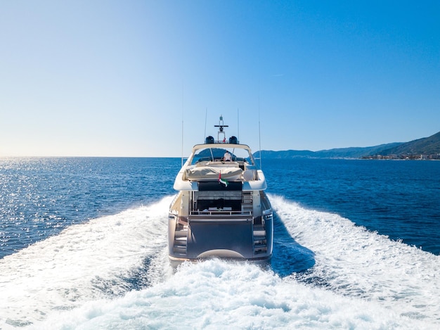 Beautiful shot of a yacht sailing on an empty sea with a blue sky in the background