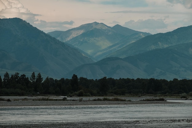 A beautiful Siberian landscape with a river against a background of mountains in the Altai Republic