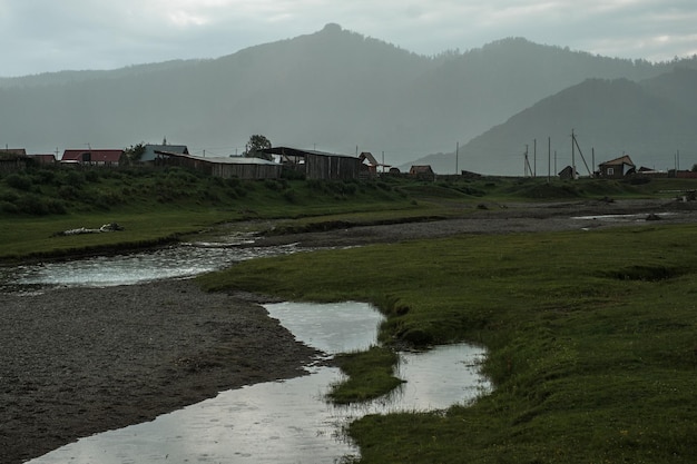 A beautiful Siberian landscape with a river against a background of mountains in the Altai Republic