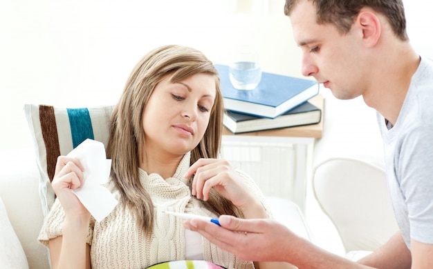 Beautiful sick woman getting pills from her boyfriend