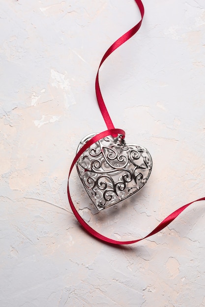 beautiful silver heart with red ribbon