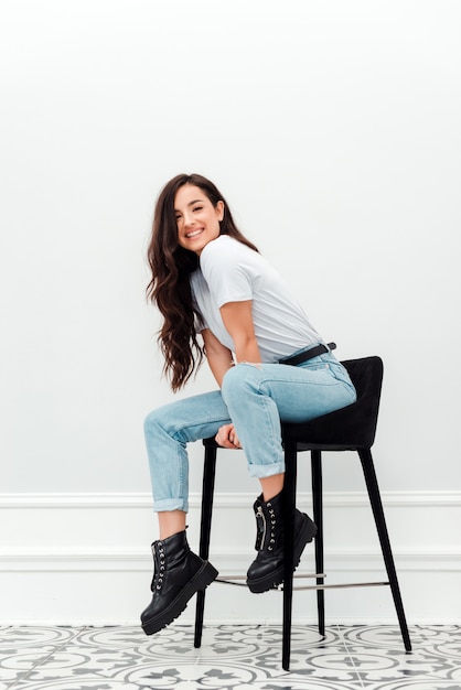 Beautiful, sincerely smiling lady sits on a chair