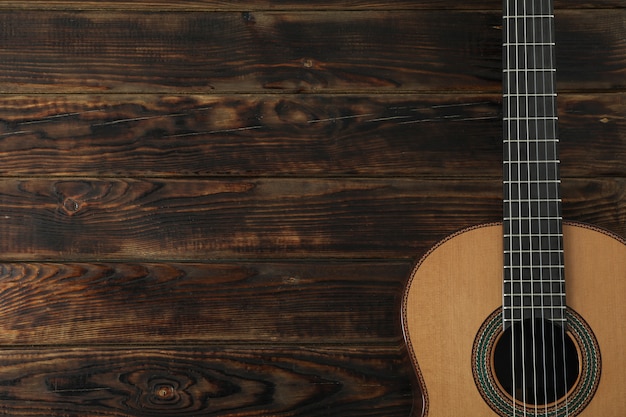 Beautiful six - string classic guitar on wooden table