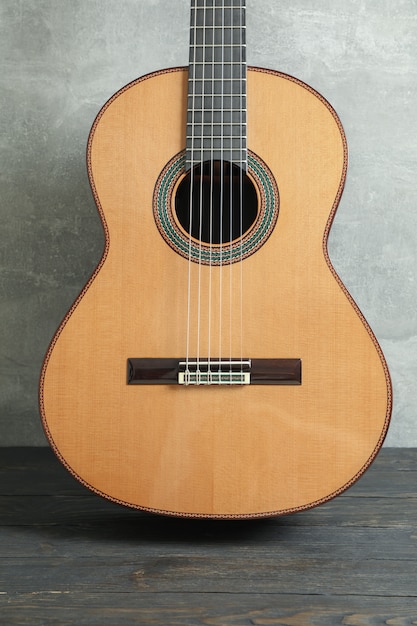 Beautiful six - string classic guitar on wooden table