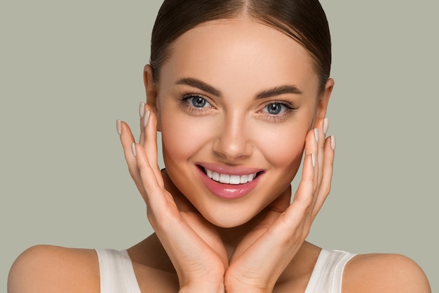 Beautiful skin face woman natural make up healthy skin touching her face. Color background. Green