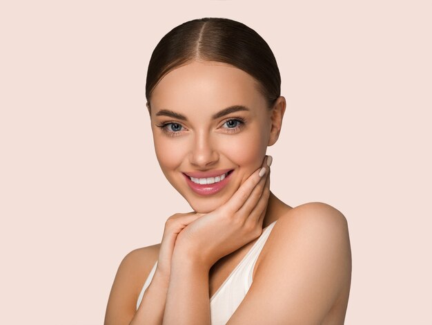 Beautiful skin face woman natural make up healthy skin touching her face. Color background. Yellow