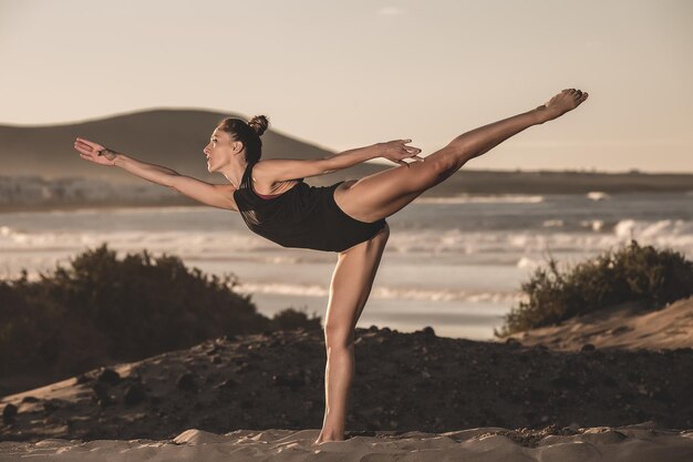 Beautiful slim woman balancing on one leg in asana