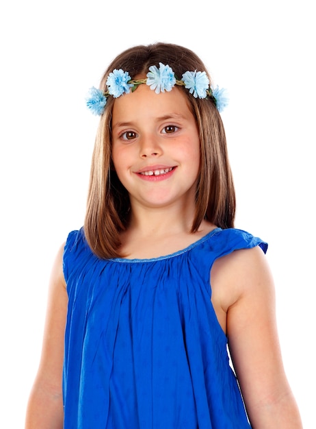 Beautiful small girl with blue dress and a flowers´ wreath on her head