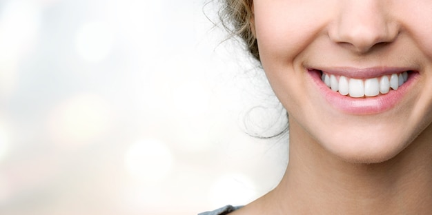 Beautiful smile of young woman with healthy white teeth