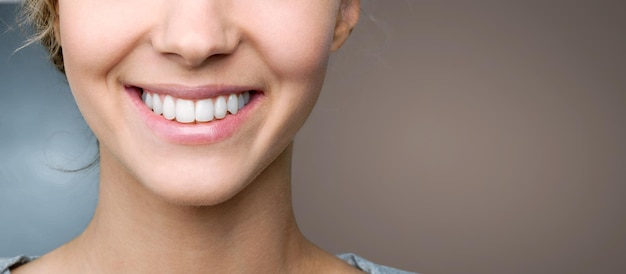 Beautiful smile of young woman with healthy white teeth