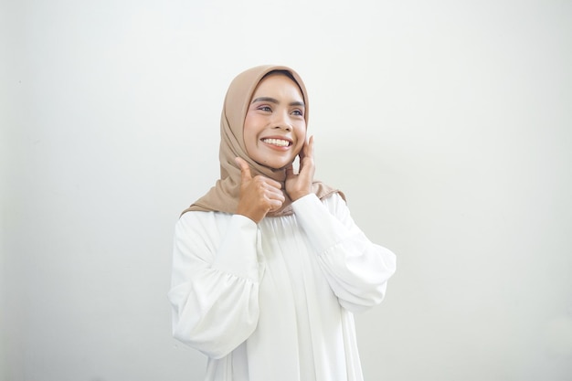 Beautiful smiling Asian woman in white casual showing thumbs up gesture with hand