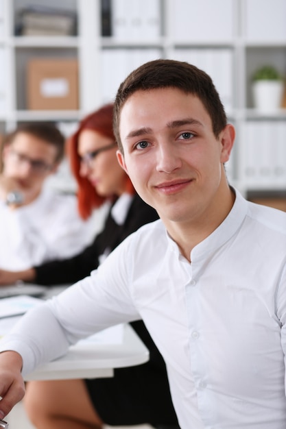 Beautiful smiling business man at workplace