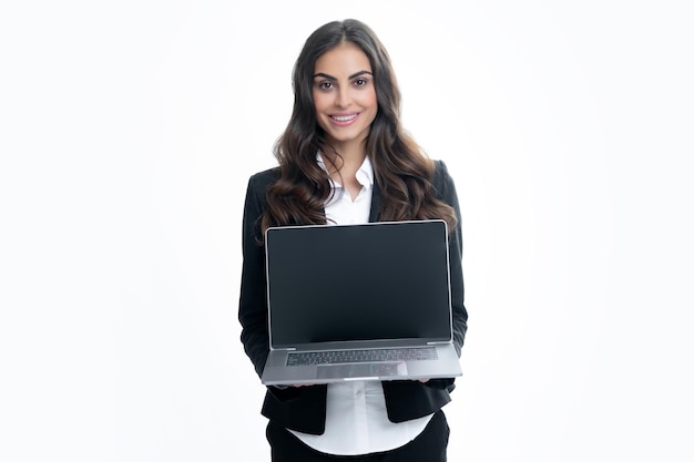 Beautiful smiling business woman over grey background using laptop computer Woman holding laptop with empty mock up screen for copy space