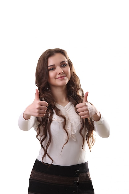 Beautiful smiling business woman standing. Thumb up.