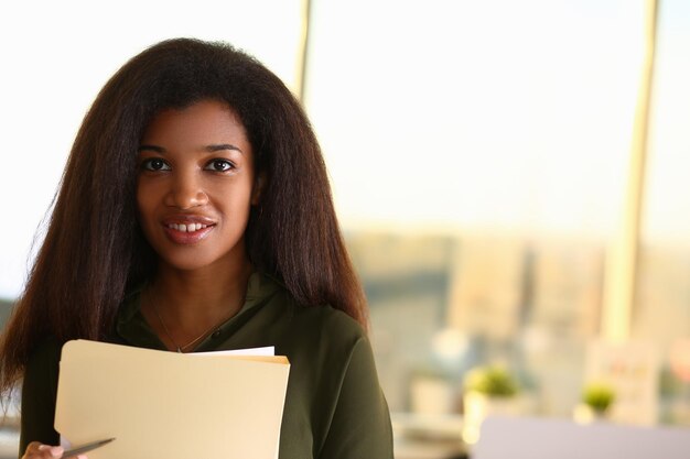 Beautiful smiling businesswoman portrait holding business documents