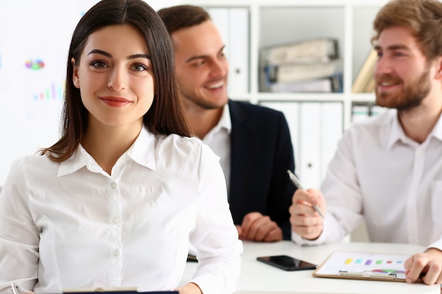 Beautiful smiling cheerful girl at workplace look