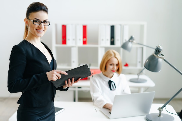 Beautiful smiling cheerful girl at workplace look