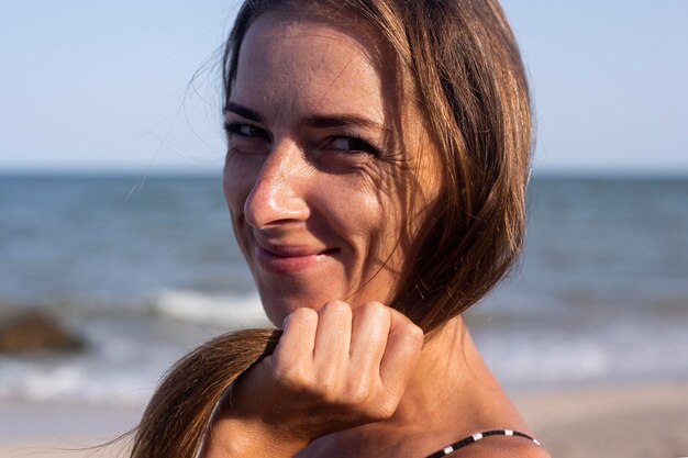 Beautiful smiling cute young woman on the beach. Travel concept.