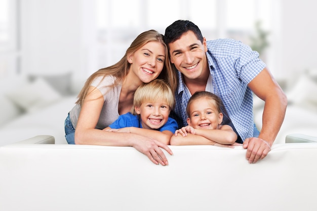 Beautiful smiling family in room on couch