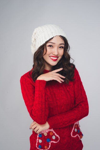 Beautiful smiling fashion model face with red lips in warm clothing