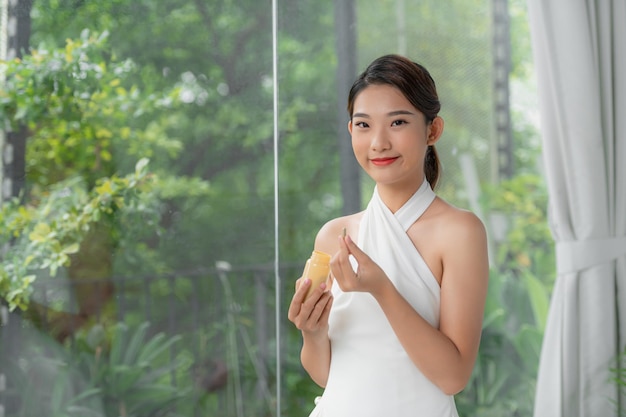 Beautiful Smiling Girl Taking Medication Holding Bottle With Pills In Hand