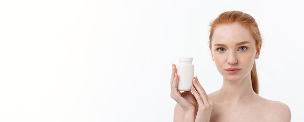 Photo beautiful smiling girl taking medication holding bottle with pills healthy happy female eating pill