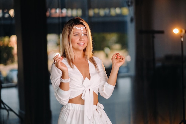 Beautiful smiling girl in a white dress dancing in the gym