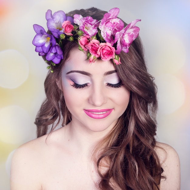 Beautiful smiling girl with flowers in her hair