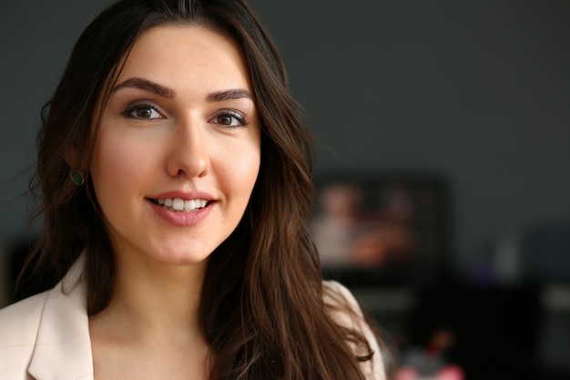 Beautiful smiling girl at workplace look in camera