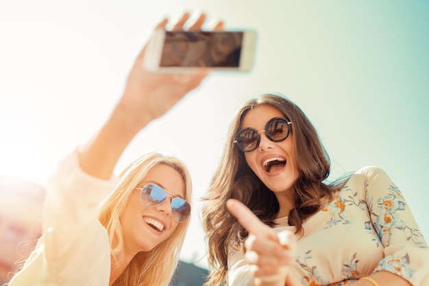 Beautiful smiling girls making selfie