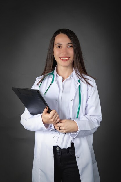 Beautiful smiling Turkish female doctor woman with patient file in her hands