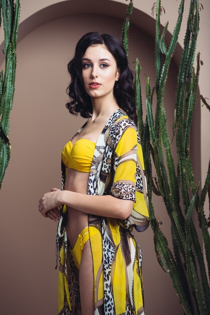 Beautiful smiling woman in a light silk tunic for the beach