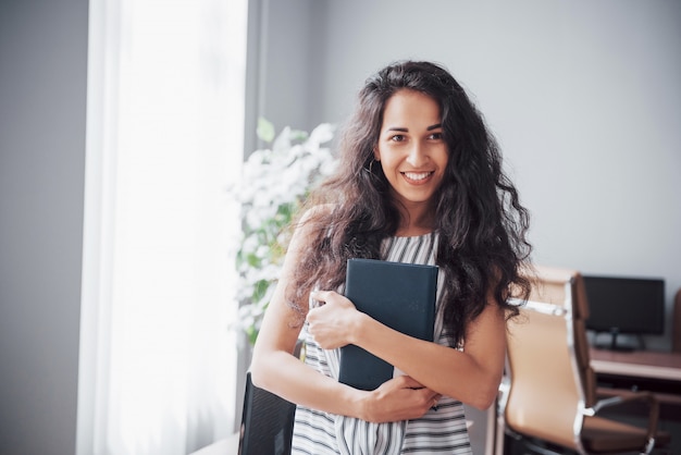 Beautiful smiling woman in office at work