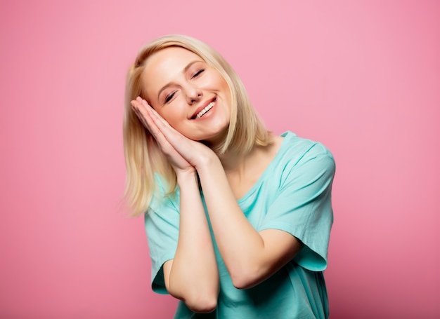 Beautiful smiling woman on pink wall