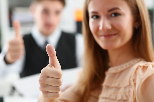 Beautiful smiling woman showing OK