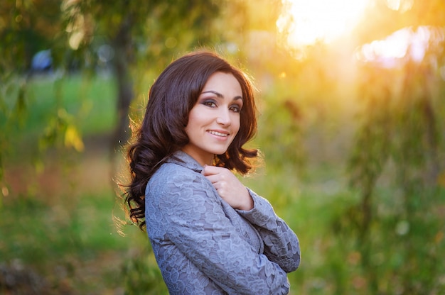 Beautiful smiling woman walking in the park