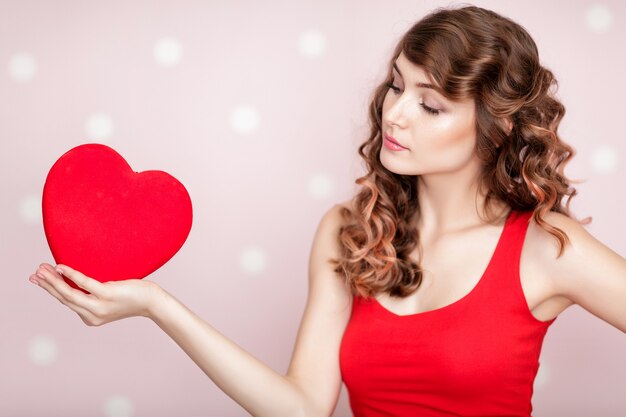 Beautiful smiling woman with red hearts for St Valentine's Day