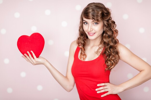 Beautiful smiling woman with red hearts for St Valentine's Day